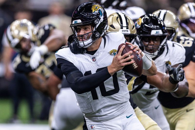 Aug 15, 2026; New Orleans, Louisiana, USA;  Jacksonville Jaguars quarterback Carter Bradley (10) scramblers from the pocket and is sacked by New Orleans Saints defensive end Myles Cole (57) during the first half at Caesars Superdome. Mandatory Credit: Stephen Lew-Imagn Images