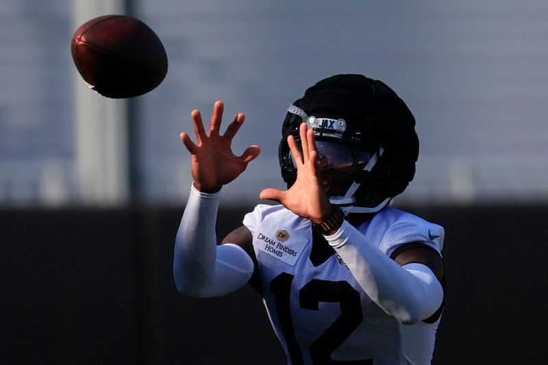 Jacksonville Jaguars wide receiver/cornerback Travis Hunter (12) catches a pass during Day 15 of NFL training camp at the Miller Electric Center on Tuesday, Aug. 18, 2026, in Jacksonville, Fla.