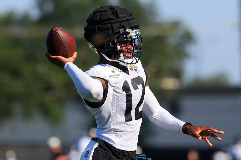 Jacksonville Jaguars wide receiver/cornerback Travis Hunter (12) tosses the ball during Day 15 of NFL training camp at the Miller Electric Center on Tuesday, Aug. 18, 2026, in Jacksonville, Fla.
