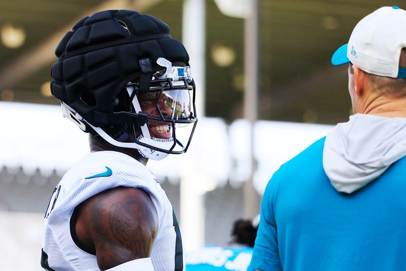 Jacksonville Jaguars wide receiver/cornerback Travis Hunter (12) smiles on the sideline during Day 15 of NFL training camp at the Miller Electric Center on Tuesday, Aug. 18, 2026, in Jacksonville, Fla.