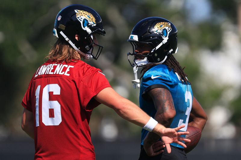 Jacksonville Jaguars quarterback Trevor Lawrence (16) and wide receiver Jakobi Meyers (3) talk after Day 15 of NFL training camp at the Miller Electric Center on Tuesday, Aug. 18, 2026, in Jacksonville, Fla.