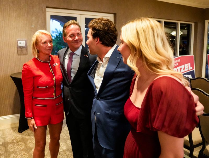 Jim Schwartzel hugs his family while celebrating after being declared the winner in the race for Florida’s 19th Congressional District during a primary election night watch party at DeRomo's restaurant ballroom in Bonita Springs, Fla., on Tuesday, Aug. 18, 2026.