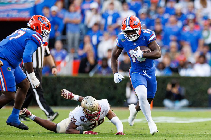 Nov 29, 2025; Gainesville, Florida, USA; Florida Gators running back Jadan Baugh (13) rushes with the ball against the Florida State Seminoles during the first half at Ben Hill Griffin Stadium. Mandatory Credit: Matt Pendleton-Imagn Images