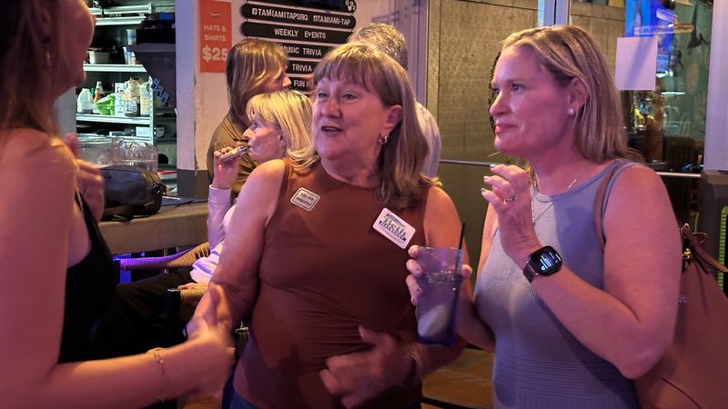 Sarasota County School Board candidates Beth Mayberry, center, and Megan Tennimon, right, celebrate with volunteers and supporters Tuesday night, Aug. 18, 2026 at Tamiami Tap in Sarasota.