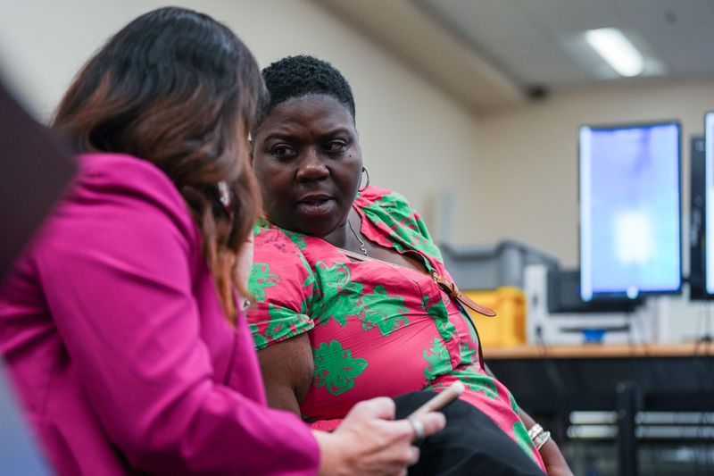 City Commission seat 3 candidate Talethia Edwards whispers with her attorney Liz Ellis as the canvassing board reviews ballots Friday, Aug. 21, 2026.