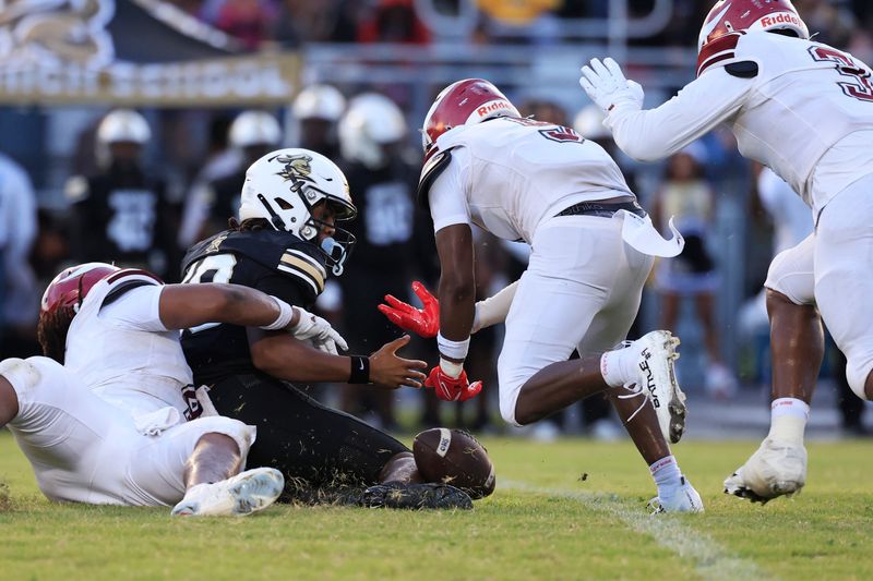 Raines defensive end Troy Butler (4) forces a fumble against Oakleaf's Jaidan Delaune during the second quarter.