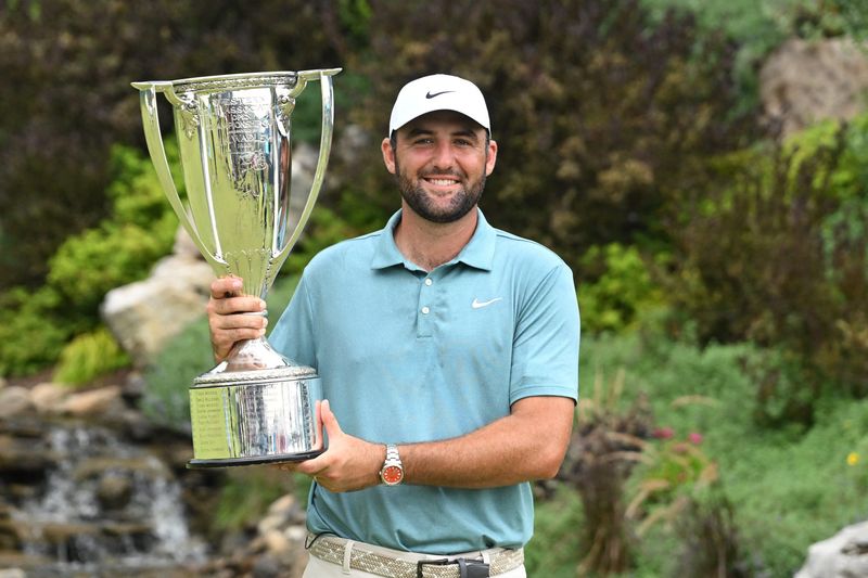 Aug 17, 2025; Owings Mills, Maryland, USA; Scottie Scheffler poses with the J. K. Wadley Trophy after winning the BMW Championship golf tournament. Mandatory Credit: Rafael Suanes-Imagn Images