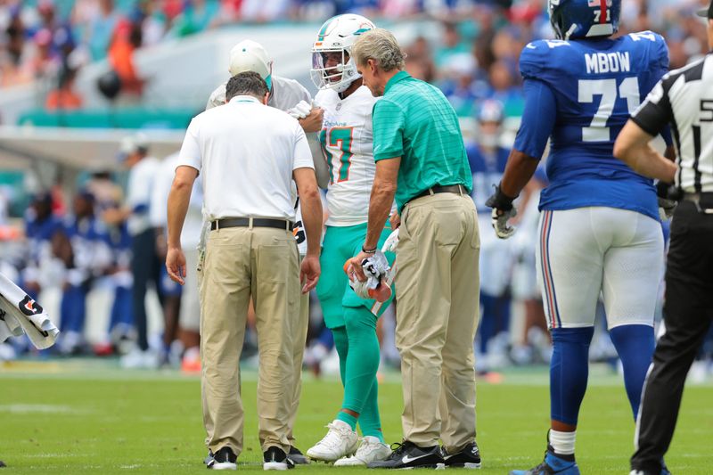 Aug 22, 2026; Miami Gardens, Florida, USA; Miami Dolphins linebacker Trey Moore (17) exits the game after an apparent leg injury against the New York Giants during the first half during the first half at Hard Rock Stadium. Mandatory Credit: Sam Navarro-Imagn Images