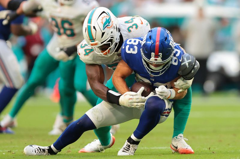 Aug 22, 2026; Miami Gardens, Florida, USA; New York Giants wide receiver Dalen Cambre (83) runs with the football against Miami Dolphins linebacker Stephen Dix Jr. (34) during the second half at Hard Rock Stadium. Mandatory Credit: Sam Navarro-Imagn Images