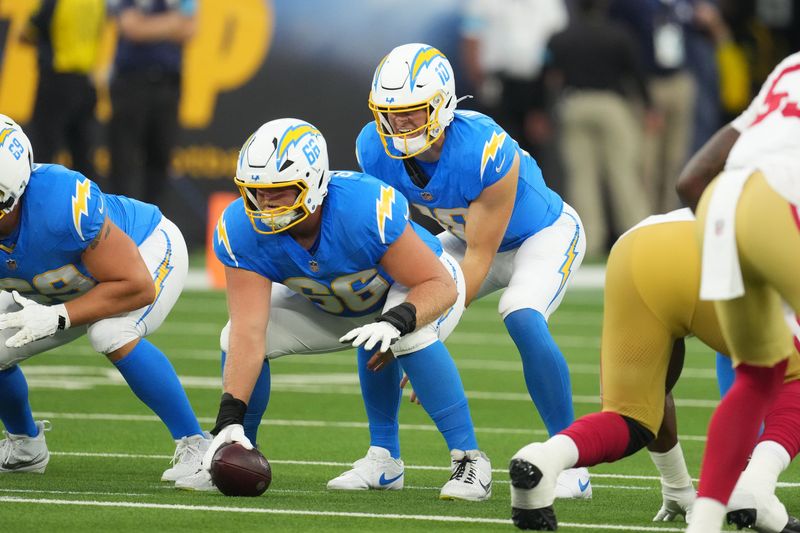 Aug 20, 2026; Inglewood, California, USA; Los Angeles Chargers quarterback Justin Herbert (10) takes the snap from center Jake Slaughter (66) against the San Francisco 49ers in the first half at SoFi Stadium. Mandatory Credit: Kirby Lee-Imagn Images