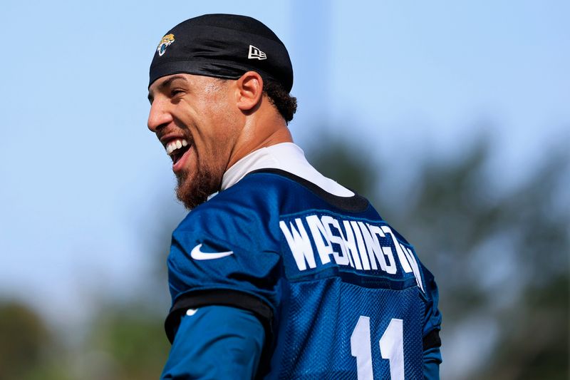 Jacksonville Jaguars wide receiver Parker Washington (11) laughs while walking on the field after Day 17 of an NFL training camp at the Miller Electric Center on Sunday, Aug. 23, 2026, in Jacksonville, Fla.