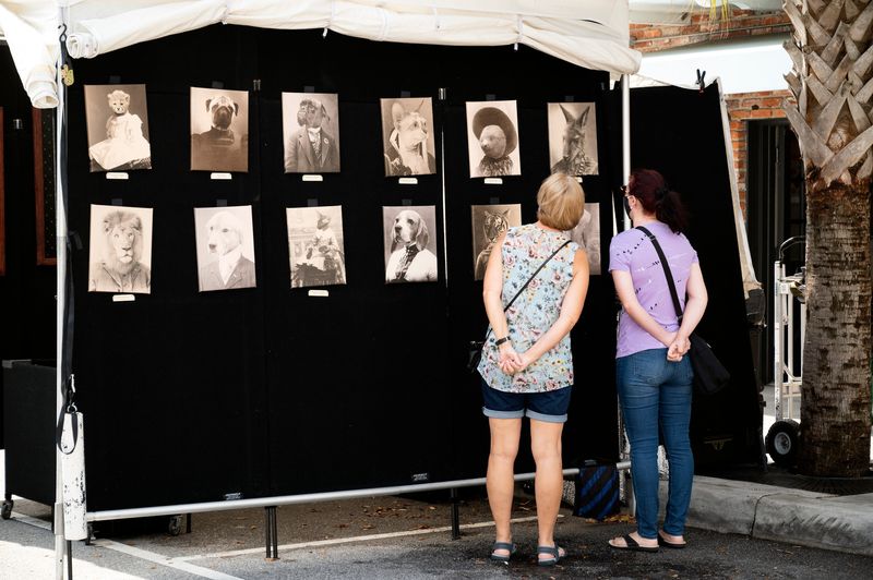 Women look at the unique artwork at the Spring Art Festival in Mount Dora in 2021.