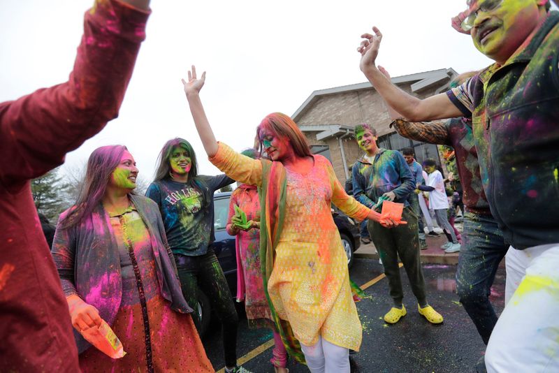 People dance and play with Holi colors during a Holi Festival Saturday, March 19, 2022, at the Hindu Temple of Northeast Wisconsin in Kaukauna, Wis. Dan Powers/USA TODAY NETWORK-Wisconsin