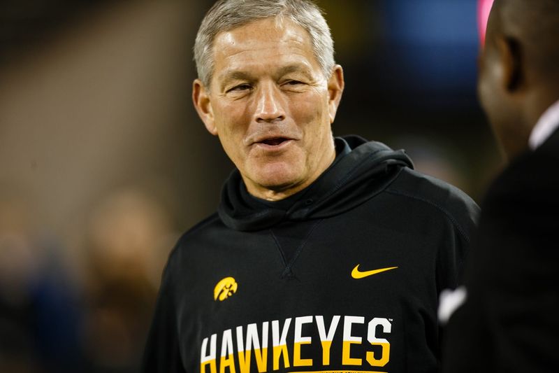 Iowa head coach Kirk Ferentz walks off the field with his players after their Spring Game on Friday, April 21, 2017, in Iowa City.