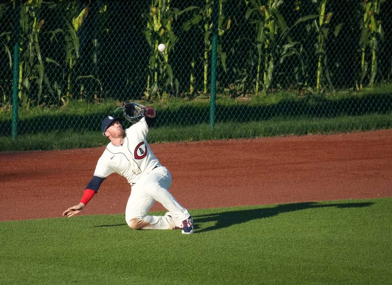 Chicago Cubs right fielder Ian Happ keeps his focus on the ball for the catch after sliding on the grass against Cincinnati during a Major League Baseball game at the Field of Dreams baseball field in Dyersville on Thursday, Aug. 11, 2022.