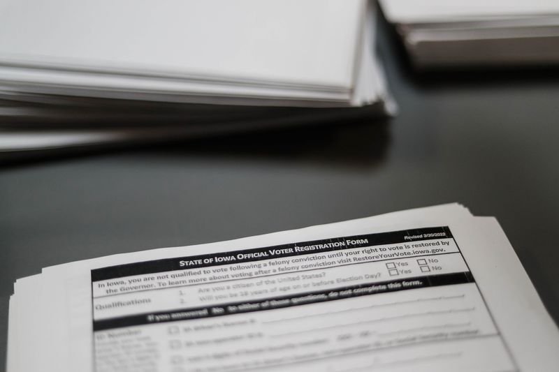 Voter registration forms sit on the front desk of the Polk County Auditor’s Office in downtown Des Moines in October 2022.