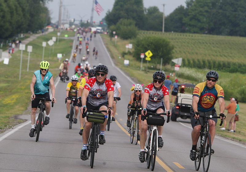 Cyclists pass through Altoona on the way to Tama-Toledo on Day 5 of RAGBRAI 50 on Thursday, July 27, 2023.