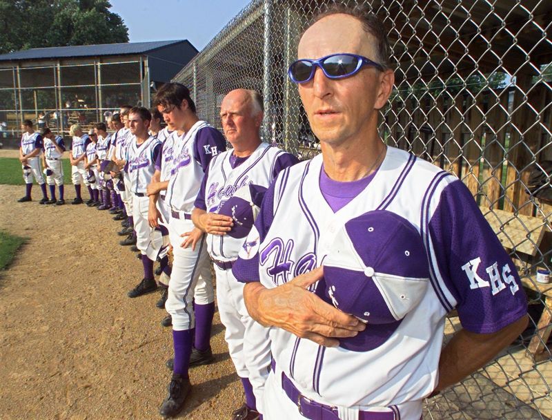 Gene Schultz and his Kee High team stand during the national anthem before a double header against Clayton Ridge in 2002.