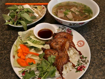 Find dishes such as the #43 com chim cut quay (roasted quail), foreground, and the Pho A Dong, top right, at A Dong.
