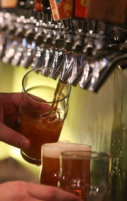 A bartender pours beer from a tap at 515 Brewing during the Inaugural Frozen Ride on Saturday, Jan. 31, 2015, in Clive, Iowa.