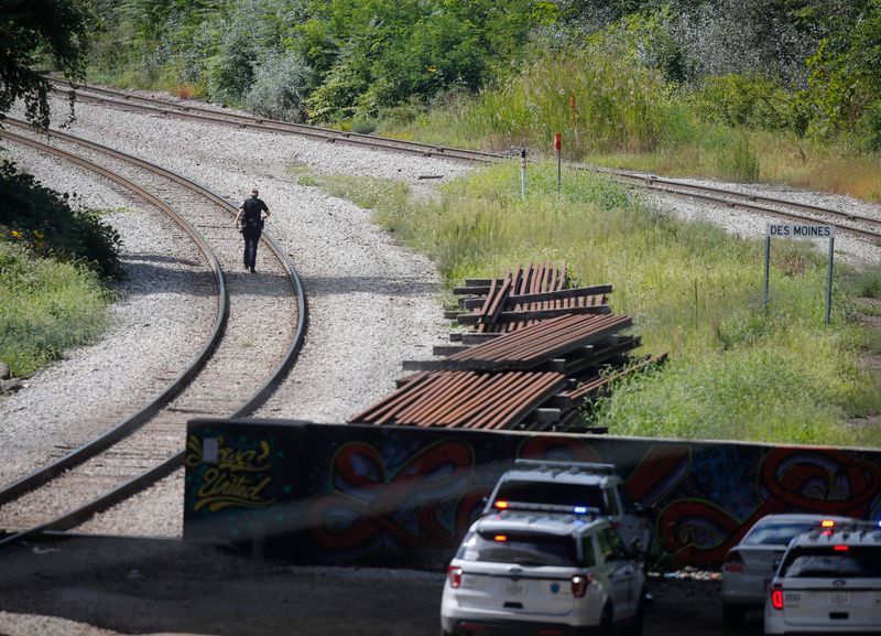 Members of the Des Moines Police Department work an area along the railroad tracks south of Grand Ave. on Friday, Sept. 13, 2019, in Des Moines after receiving a call about a shooting in the area.
