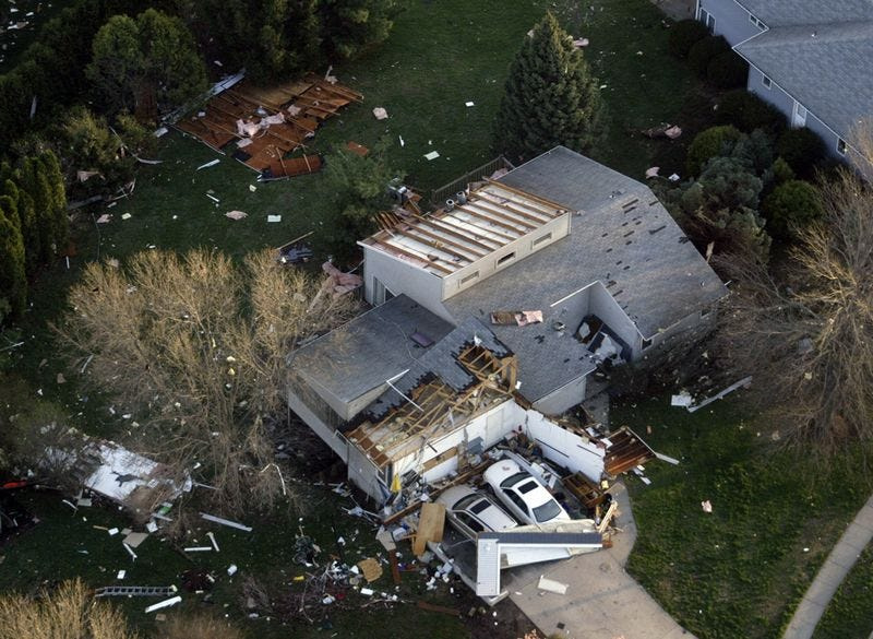 An aerial view of a damaged home near Hickory Hill Park in Iowa City.
