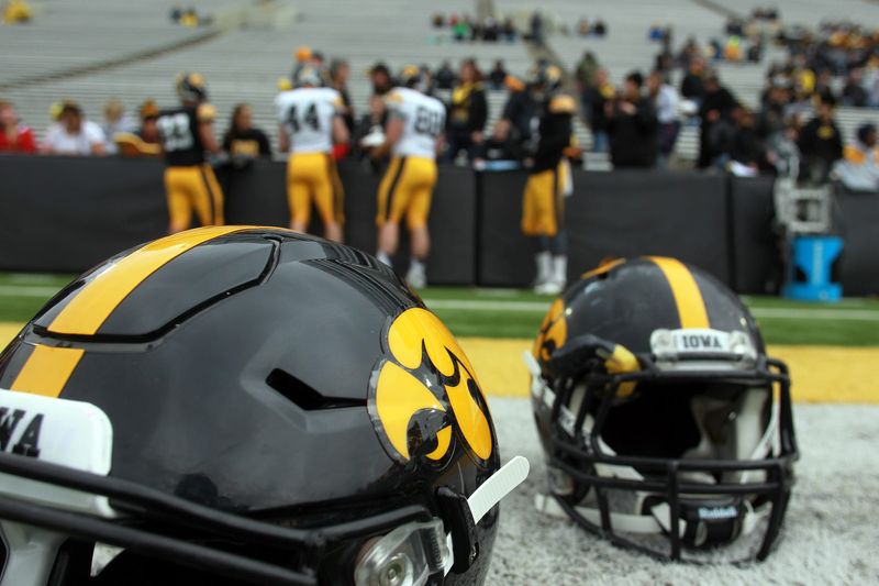 Helmets rest on the ground as players sign autographs prior to the Hawkeyes' open spring game at Kinnick Stadium on Saturday, April 25, 2015.