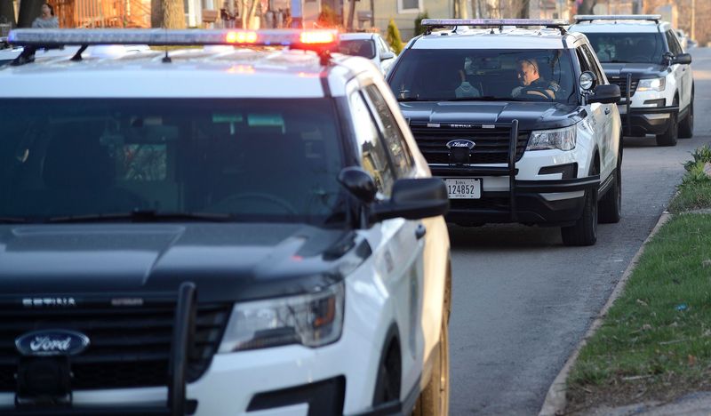 Des Moines Police Department patrol vehicles are lined up at a scene.