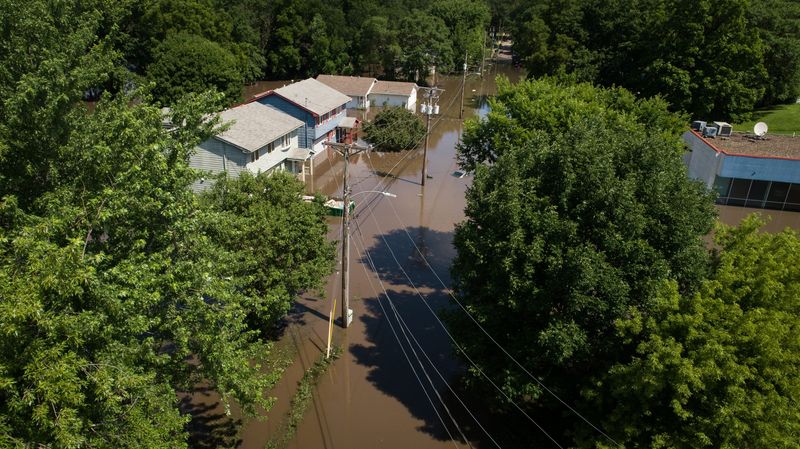 Flood waters spill over Four Mile Creek on Sunday, July 1, 2018 after flash flooding Saturday night in Des Moines.