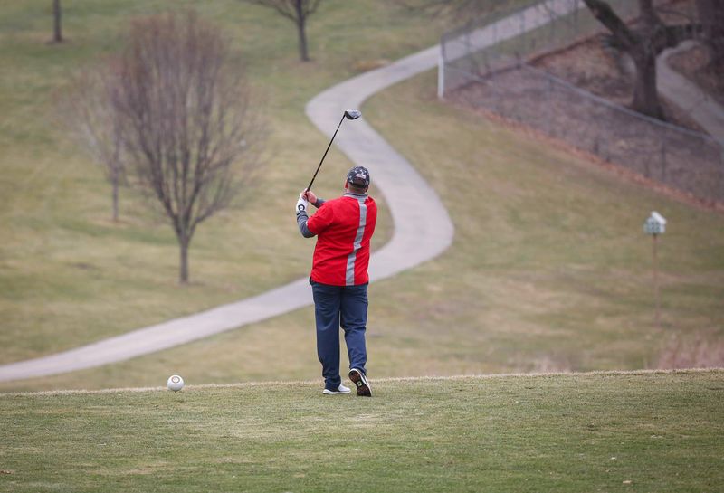 A golfer tees off on Saturday, March 13, 2021, at Waveland Golf Course in Des Moines.
