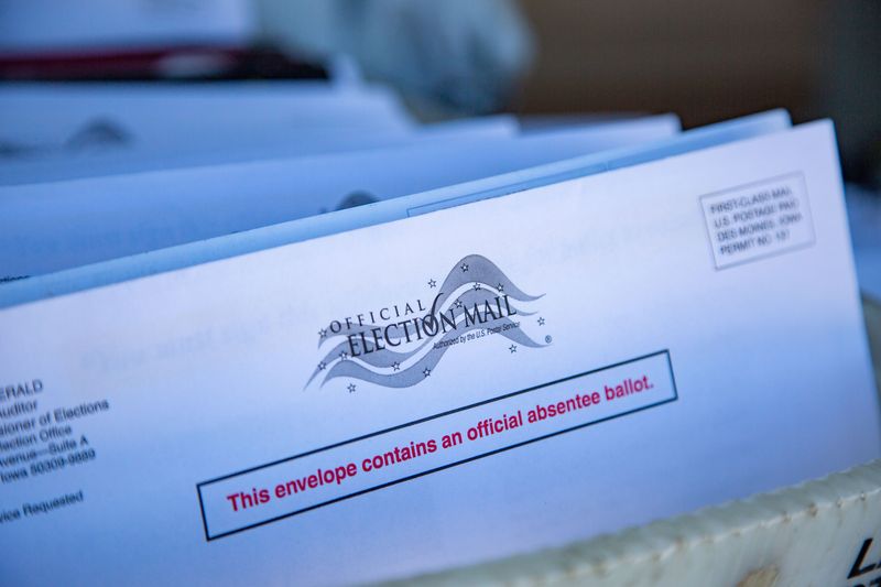 Absentee ballots sit in the back of city letter carrier Keith Brown's mail truck in Altoona on Wednesday, Oct. 7, 2020. The USPS is delivering the ballots to homes around Polk County. Iowans who request absentee ballots but do not want to return them through the mail have the option of hand-delivering the ballots to their county auditor's office.