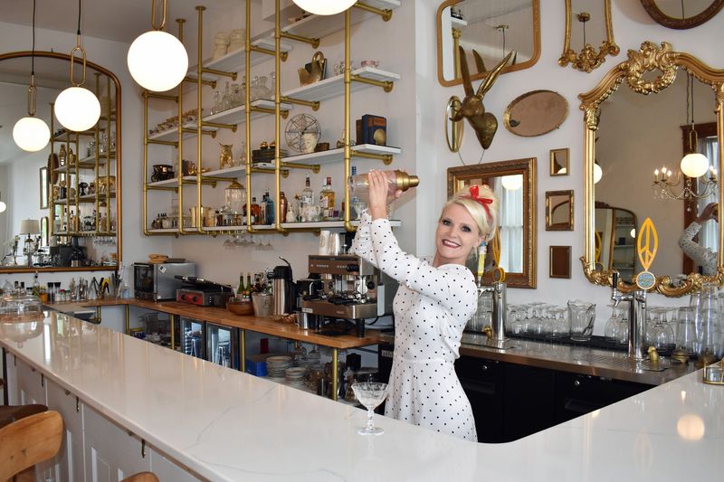 Cyndi Gryte shakes up a cocktail at Juniper & Olive Co., her bistro on Main Street in Jewell, Iowa.