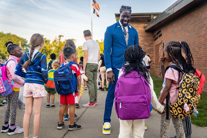 Des Moines Public Schools Superintendent Ian Roberts talks with students before the first day of school at Samuelson Elementary in Des Moines, Wednesday, Aug. 23, 2023.