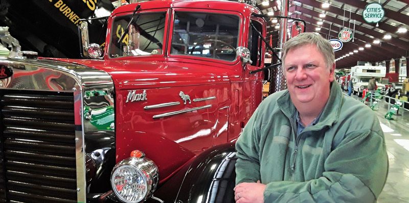 Will Moon sits next to one of his favorite trucks, a 1955 Mack, in the Iowa 80 Trucking Museum next to his company office in Walcott in 2021.