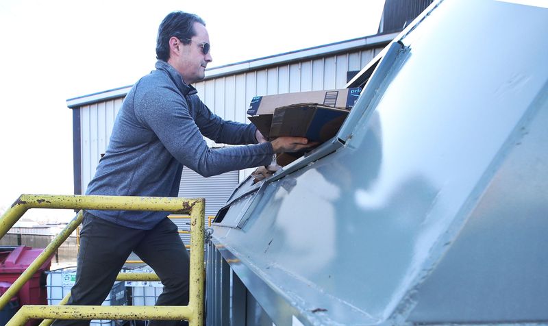 Ames resident Jeramy Ashlock recycle the newly installed containers for cardboard, plastics, paper, and glasses at Ames Resource Recovery on Tuesday, Jan. 2, 2024, in Ames, Iowa.