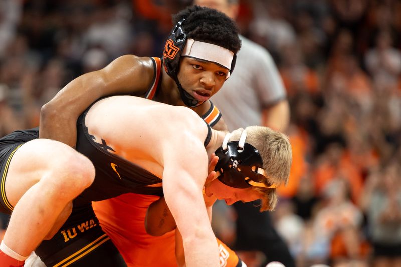 Jordan Williams, top, wrestles for Oklahoma State on Feb. 25, 2024. Williams announced in March that he would transfer from Little Rock to Iowa.