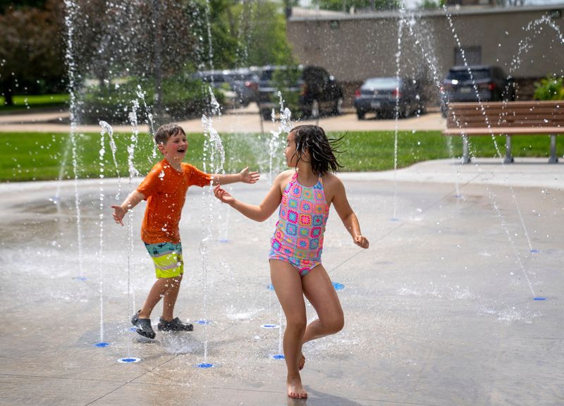 Judah McLellan, 7, Saylah Attig, 9, play on the new splash pad at Haines Park in Altoona, Tuesday, May 28, 2024.