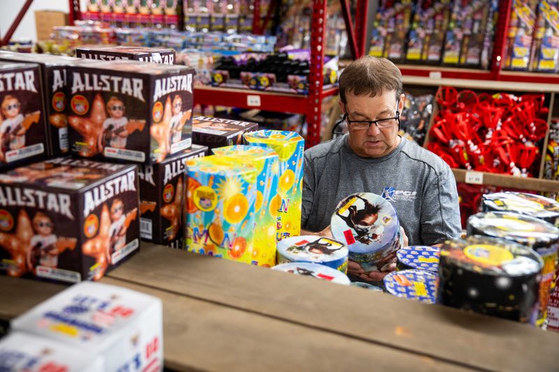 Brad Sandstow works to organize and take inventory of the fireworks for sale at Jake's Fireworks on Monday, July 1, 2024, at 2221 E. Euclid Ave. in Des Moines.