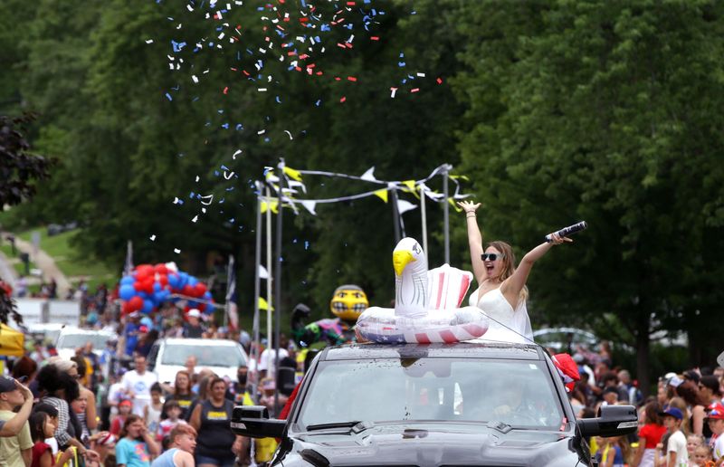 Confetti flies above a 4th Fest parade float Thursday, July 4, 2024 in Coralville, Iowa.