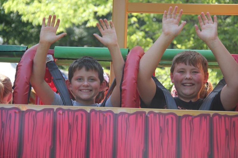 Brothers Lucas (9) and Abram Ritchhart (11) have fun on one of the carnival rides at the Dallas County Fair on Thursday, July 11, 2024, in Adel.