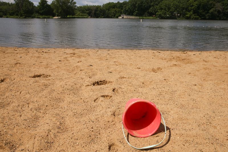 A pail sits on the beach at Backbone Lake Wednesday, July 17, 2024 near Dundee, Iowa.