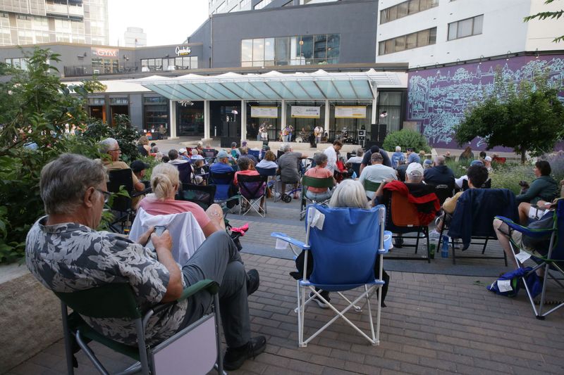 People gather on the Ped Mall to watch Charlotte Blu and Natural Habits perfrom during the Friday Night Concert Series Friday, July 19, 2024 in Iowa City, Iowa.