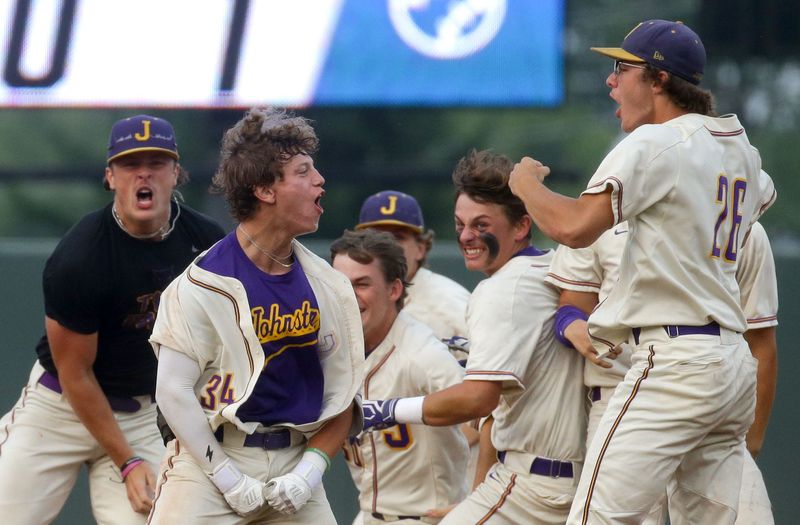 Johnston’s team mobs Mason Tell, 34, second from left, after he had the winning RBI against Waukee Northwest in the quarterfinals of the Iowa high school state baseball tournament Tuesday, July 23, 2024 at Veterans Memorial Stadium in Cedar Rapids, Iowa.