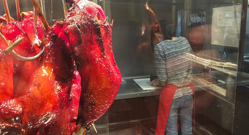 After 22 years on Second Avenue, Le's Chinese Bar-B-Que closed iin 2024, but hopes to open on Douglas Avenue on the northside of Des Moines. Barbecue duck hangs inside the restaurant, ready for customers.
