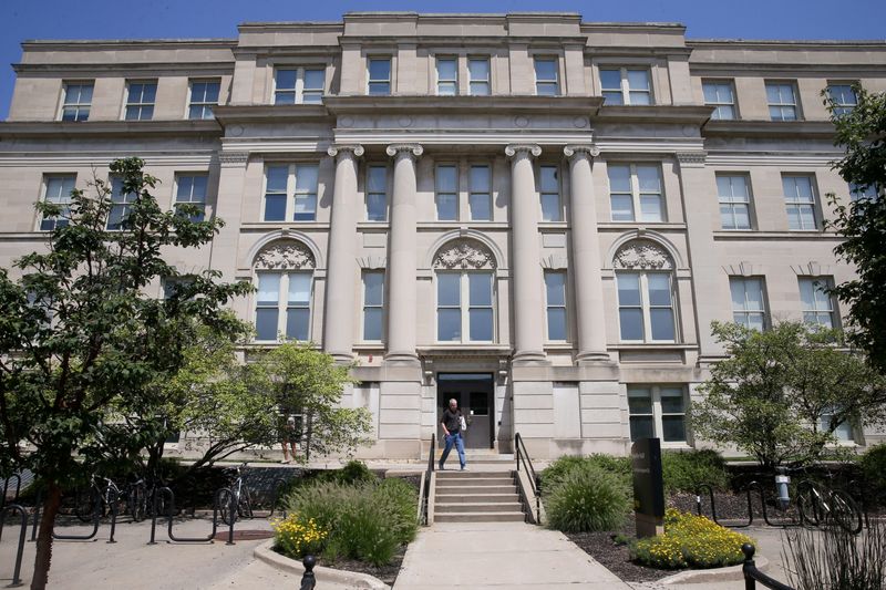 A person walks in front of Schaeffer Hall on the University of Iowa campus Wednesday, July 31, 2024 in Iowa City, Iowa.