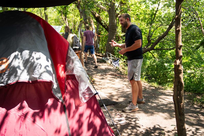 PHC Street Outreach's Josh Wittenberg talks with homeless individuals during the biannual point in time count on Wednesday, July 31, 2024, in Des Moines.