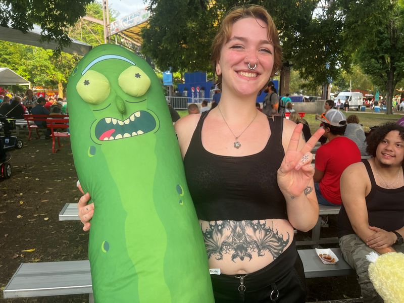 Crystal Hochart from Des Moines won a stuffed version of Pickle Rick from the hit animated series "Rick and Morty" at the Iowa State Fair on Aug. 13, 2024.
