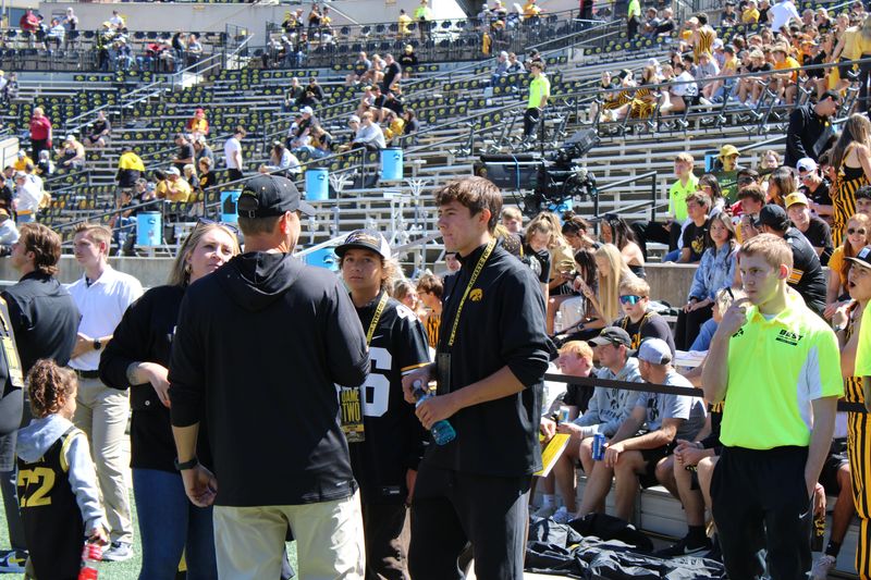 2026 QB Cash Herrera with Iowa offensive coordinator Tim Lester prior to the Cy-Hawk at Kinnick Stadium.