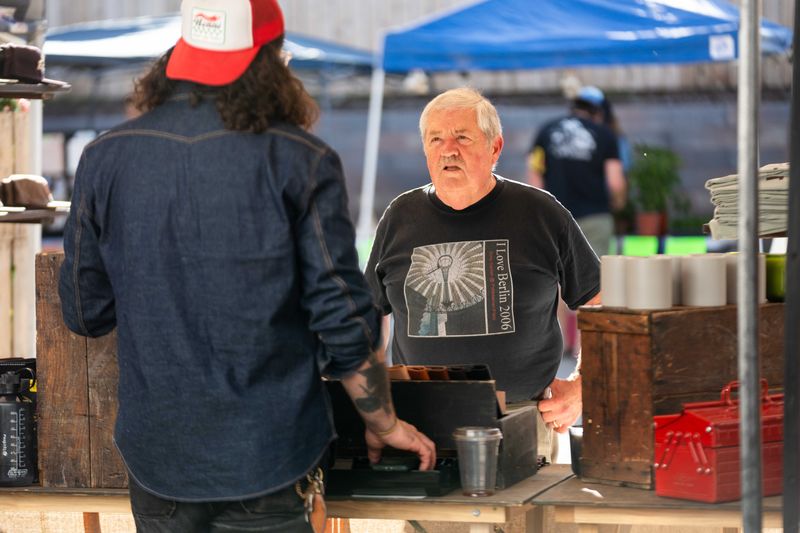 Warren Riedesel shops at the vendor's booths during Oak Park's first-ever outdoor vendor market on Monday, Sept. 16, 2024, in Des Moines.