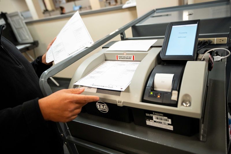Test ballots are fed into the vote tabulator machine during a test demonstration on Thursday, Oct. 3, 2024, at the Polk County Elections Office in downtown Des Moines.